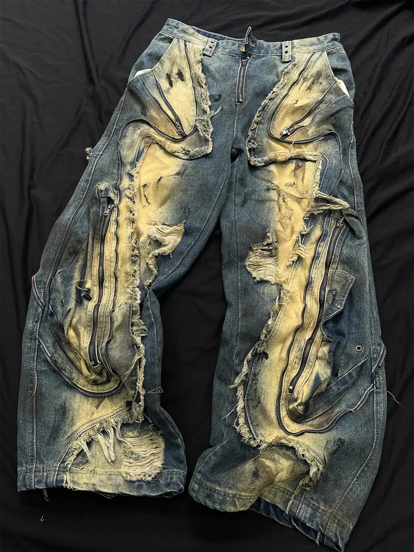 Men's distressed cargo jeans with artistic ripped design showcasing bold street style.
