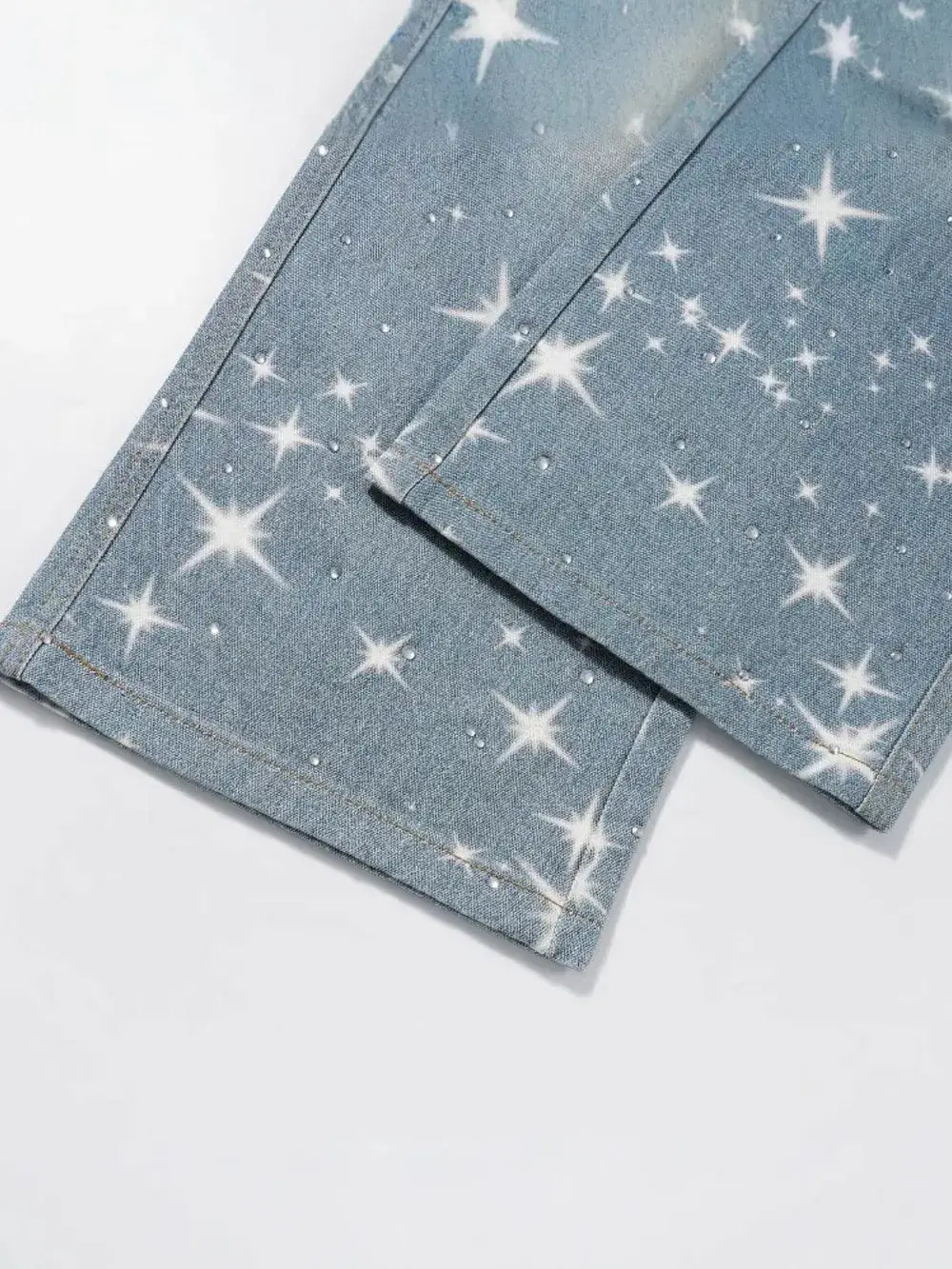 Close-up of StarPrint Rhinestone Washed Jeans for men showcasing rhinestones and star pattern on denim.