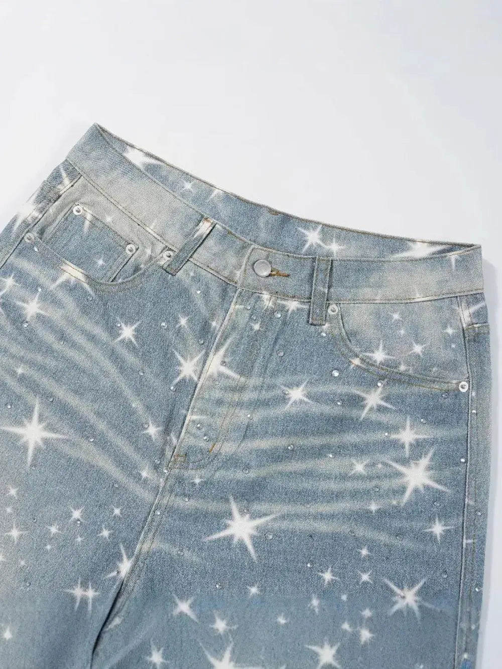 Close-up of StarPrint Rhinestone Washed Jeans for men featuring a starry design and rhinestones on denim.